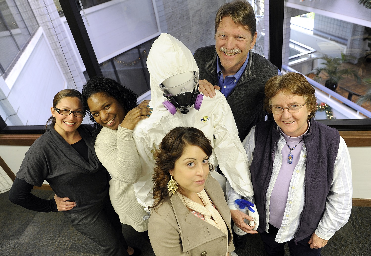 photo people standing with a mannequin wearing personal protective equiptment